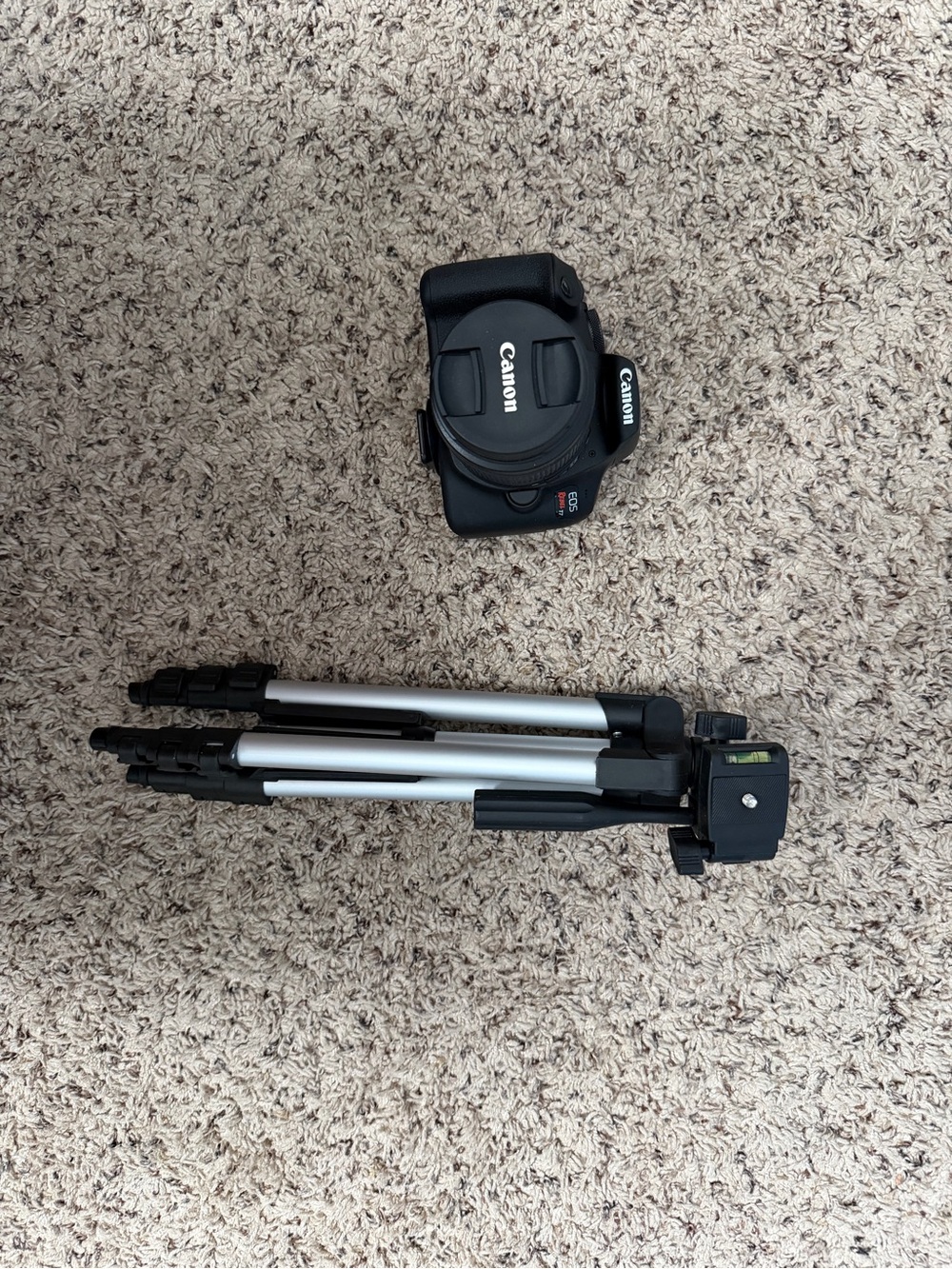 Canon Black Camera Body with Black and Silver Tripod